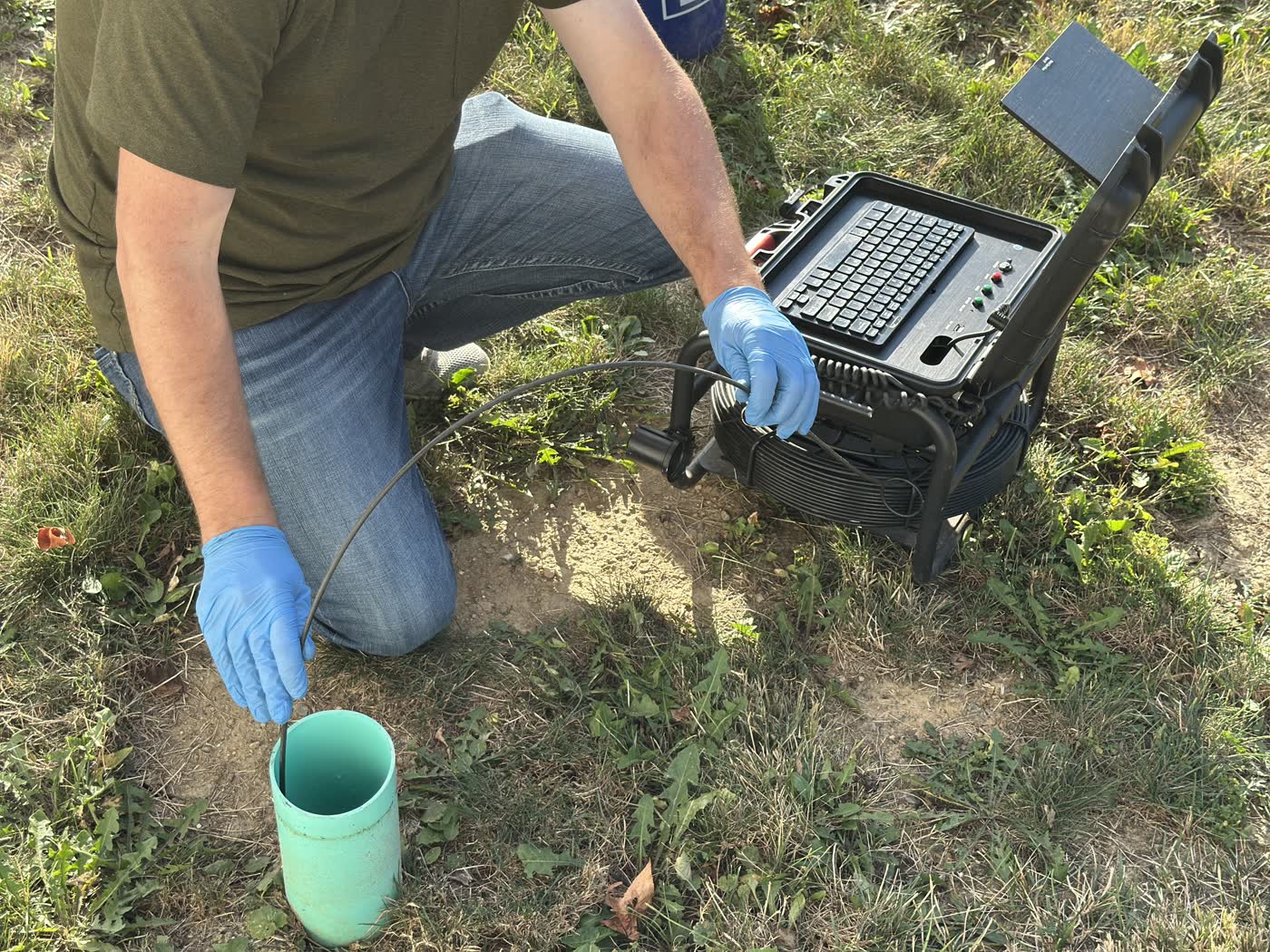 Feeding the camera cable into a side-yard cleanout on an Indianapolis pre-purchase scope.