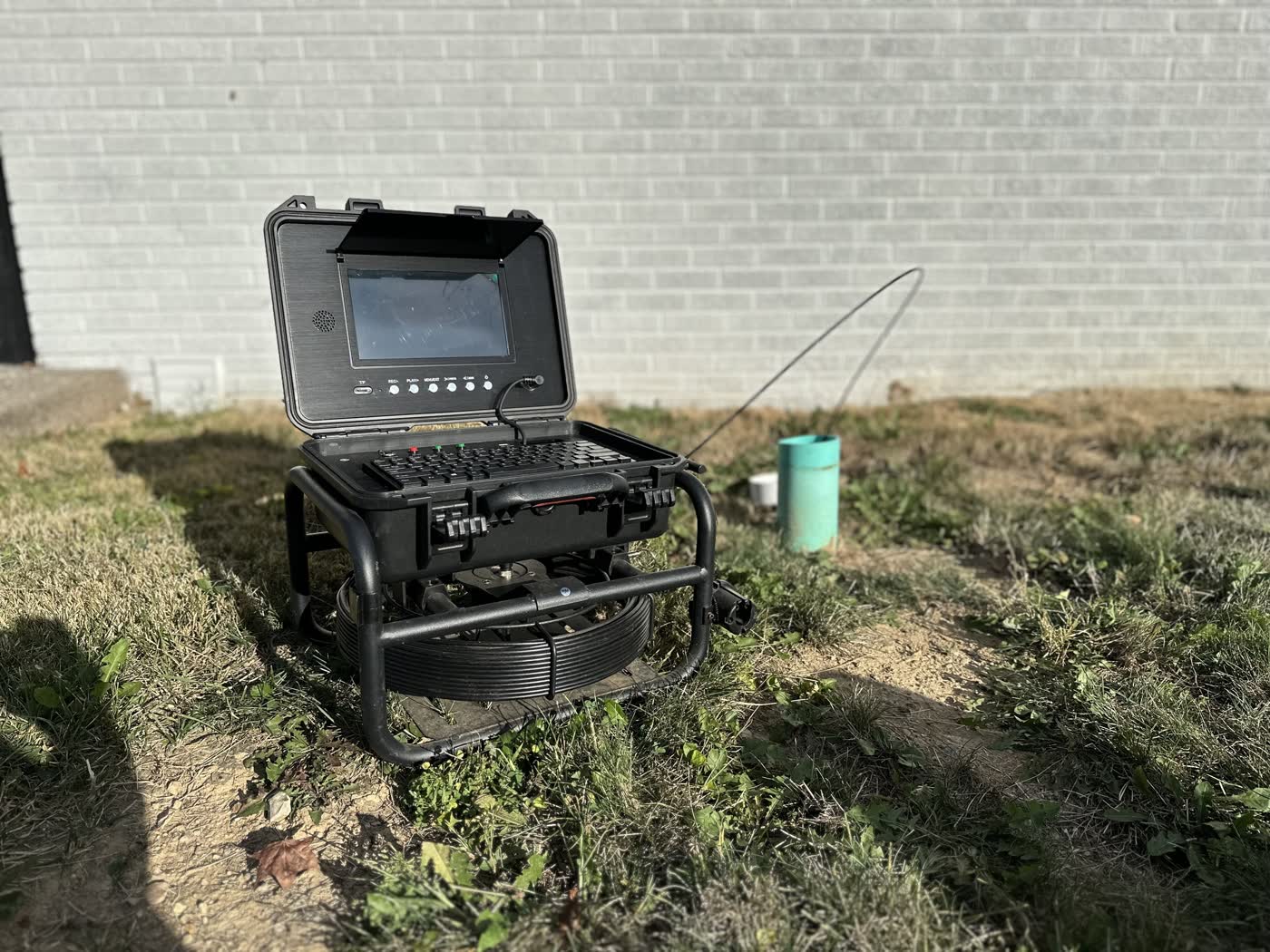 Sewer scope monitor and cable reel staged outside a Cincinnati area home.