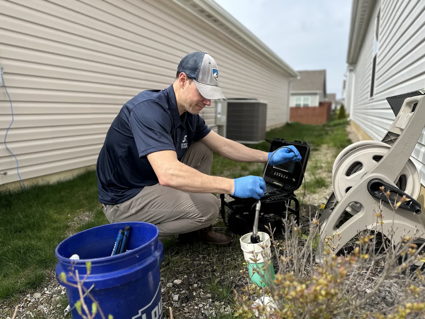 Sewer Scope inspector running a residential scope from a yard cleanout in Allen County.